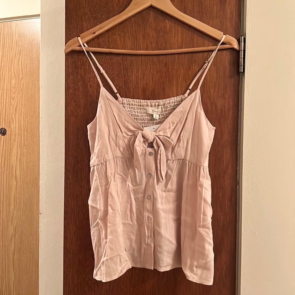 Small pink top with adjustable straps and ribbon detail. Never worn, tags on.